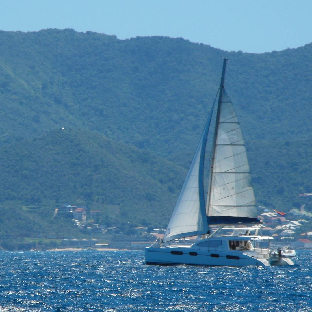 ARAVILLA under sail in the turquoise waters of