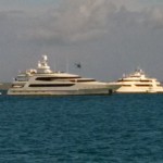 Mega yacht being circled by helicopter